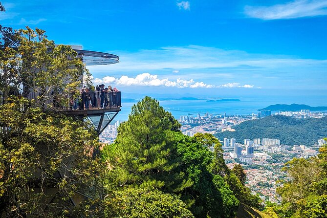 Tourists on the elevated skywalk platform at Penang Hill overlooking George Town and the coastline, Penang, Malaysia